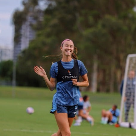Image Of Shea-Connors Running And Waving On Field